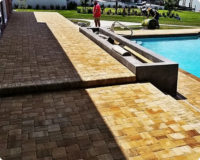 Paver pool deck along a raised spa wall